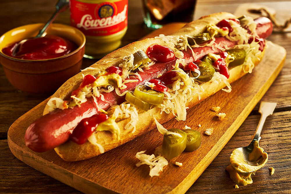 Hot Dog in a roll on a wooden board nicely decorated