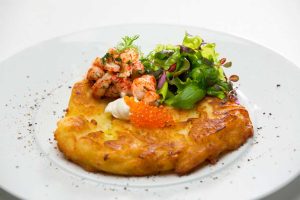 gluten free potato rosti on plate with salad